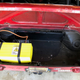 Fitting the battery into the trunk.